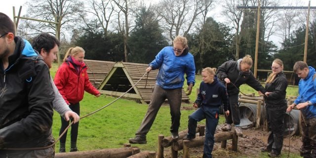 Young people at an outdoor team-building activity