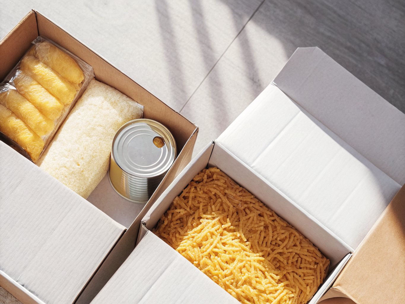 Boxes of tinned food, pasta and packaged groceries packed and ready to be donated