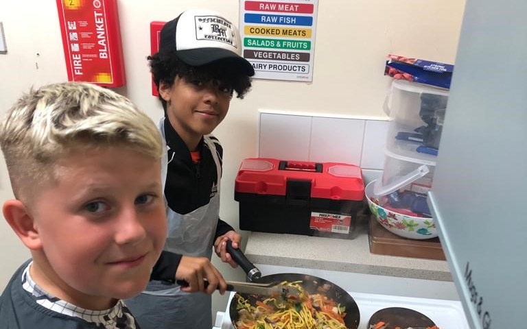 Young people cooking a stir fry at Foundation Futures