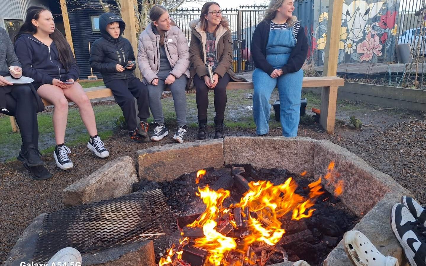 Young people around the fire at Projects 4 Change