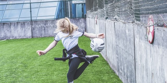A young person playing football at a Northbourne activity day