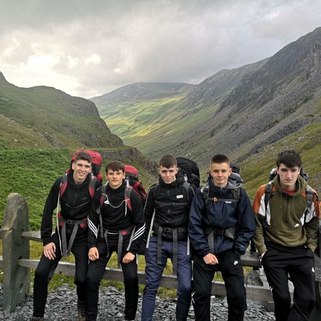 A group of young people on an outdoor expedition in the hills
