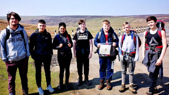 A group of young people on a hillside expedition