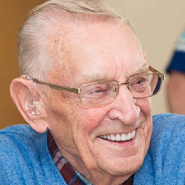 An older person smiling during a SEARCH Newcastle session