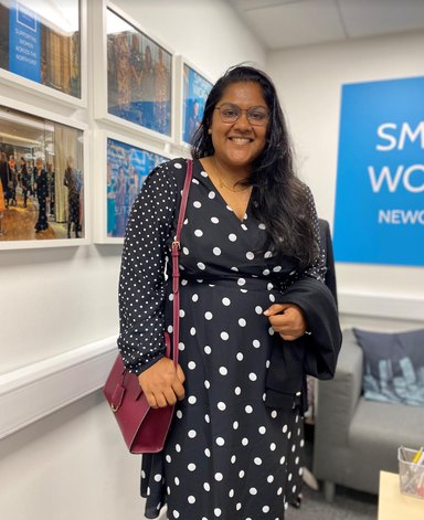 Dona, who Smart Works Newcastle supported into work, standing in the Smart Works studio